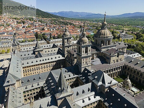 Close-up of a historic monastery with towers  surrounded by a town and mountains in the background  aerial view  Real Sitio de San Lorenzo de El Escorial  Royal Seat of St Lawrence of El Escorial  palace and monastery complex  San Lorenzo de El Escorial  Madrid  Spain  UNESCO World Heritage Site  Europe