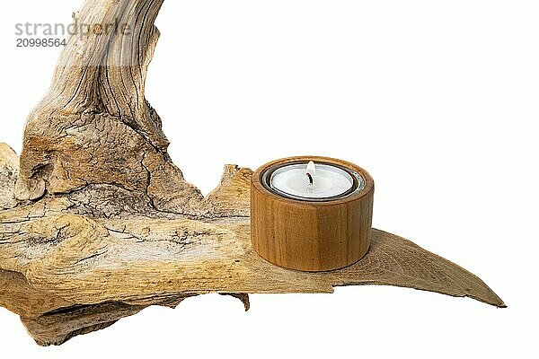 Burning tea light stands on a light-coloured tree root  isolated on white as decoration