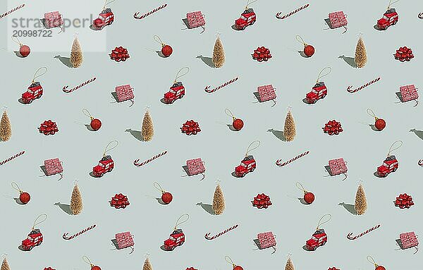 Gray green background pattern with Christmas  New Year symbol attribute objects and symbolic items concept. Small red taxi car toy  pink gift box present  lolli pop candy  lollypop  ball  fir tree