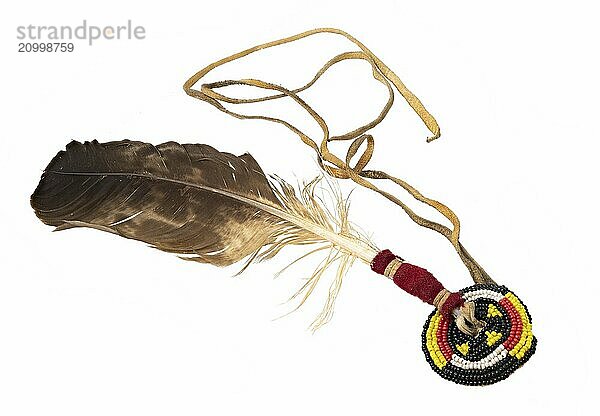 Eagle feather with beaded embroidery as an Indian hair ornament on white