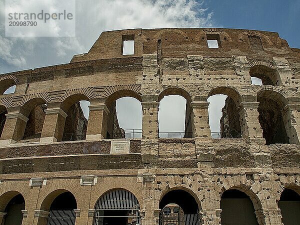 Side view of the Colosseum with arches and textured walls  Rome  Italy  Europe