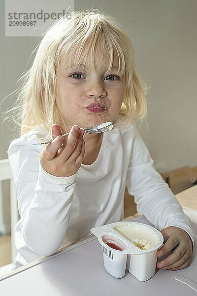 Portrait of blonde girl  3 years old  having lunch in Ystad  Skåne County  Sweden  Scandinavia  Europe