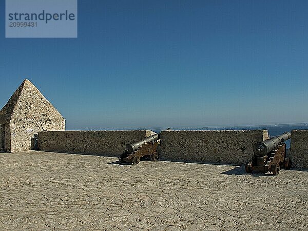 Historic fortress with cannons and sea view  bright blue sky  ibiza  mediterranean sea  spain