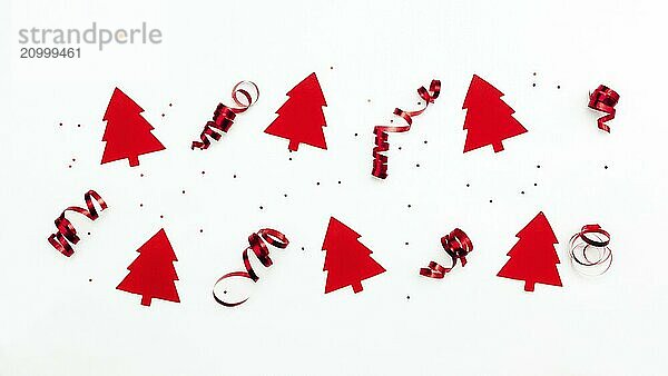 Christmas trees with red ribbons and glitter stars on white background.