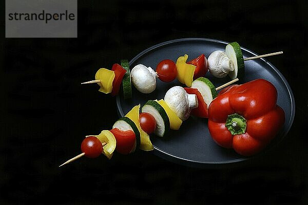 Colourful vegetable skewers on a plate  barbecue skewers