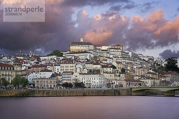 Coimbra city view at sunset with Mondego river and beautiful historic buildings  in Portugal