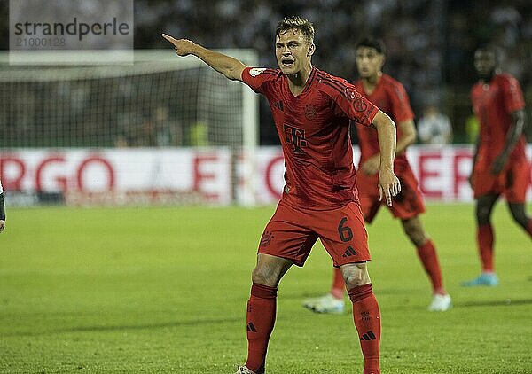 Football match  Joshua KIMMICH FC Bayern Munich shows with his left arm in which direction to go  football stadium Donaustadion  Ulm  Germany  Europe