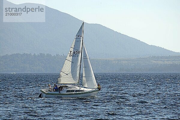 MOANA  NEW ZEALAND  FEBRUARY 6  2016: Family and friends enjoy their sailing boat on Lake Brunner  February 6  2016  New Zealand  Oceania