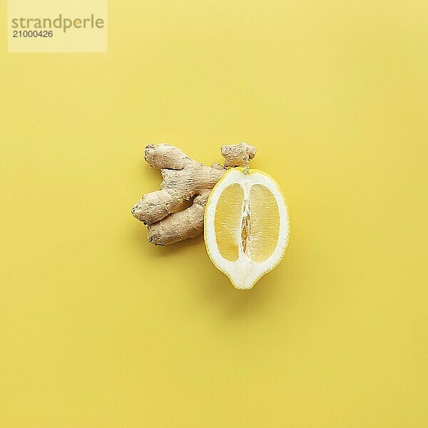 Half of lemon and ginger on yellow background. Healthy eating  antivirus concept