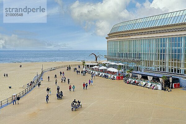 People walking and resting on Ostende promenade near the Kuursal casino  Ostende  West Flanders  Belgium  Europe