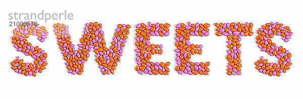 Word SWEETS colorful pattern made from dragee candies isolated on white background. High res stitched image