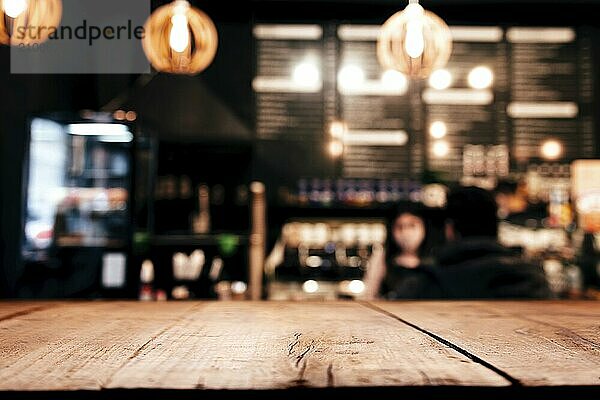 Empty blank wooden old deck table in front of abstract blurred festive background in bar  cafe  pub or restaurant with light spots and bokeh for product montage display of product. Copy space area