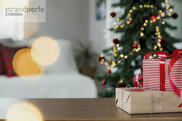 Christmas  New Year background with copy space for design. Empty tabletop surface  blurred decorated Christmas fir tree composition  bokeh lights effect  boxes with gifts. Mockup for product montage