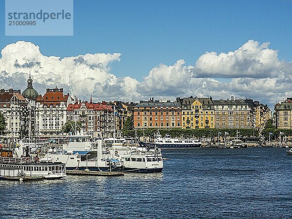 View of a busy harbour with several ships and boats surrounded by urban buildings under a blue sky  stockholm  baltic sea  sweden  scandinavia