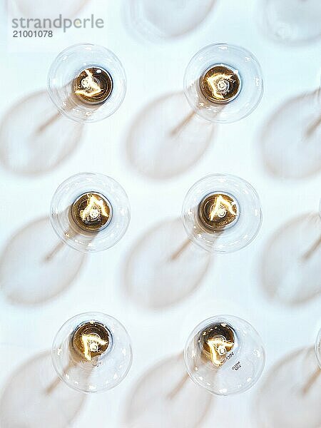 Lit incandescent tungsten light bulbs on light blue background