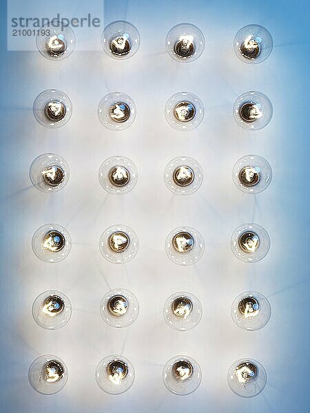 Group of lit incandescent tungsten light bulbs on blue background