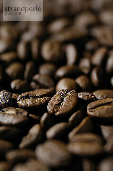 Stock photo of Coffee beans macro with artistic shallow focus background texture