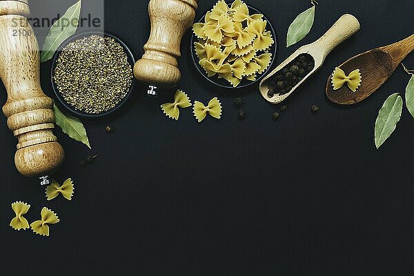 Seasonings  herbs and pasta on black background.