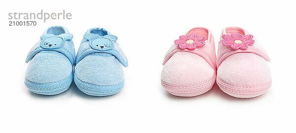 Closeup of cute pink and blue baby boy and girl shoes isolated on white background