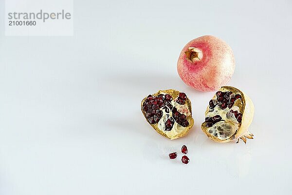 Ripe pomegranate on white background