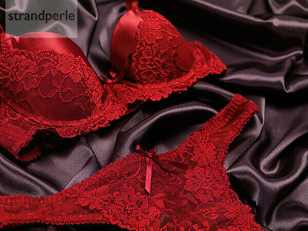 Dark red lacy lingerie womens underwear on black background