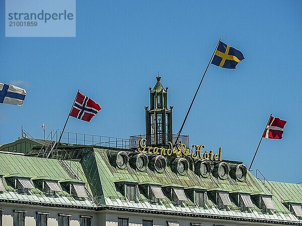 Hotel with several national flags on the roof under a blue sky  stockholm  baltic sea  sweden  scandinavia