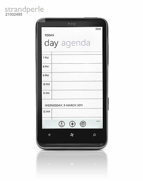 Windows 7 phone. HTC HD7 smartphone with day agenda organizer on its display isolated with clipping path on white background. High quality photo