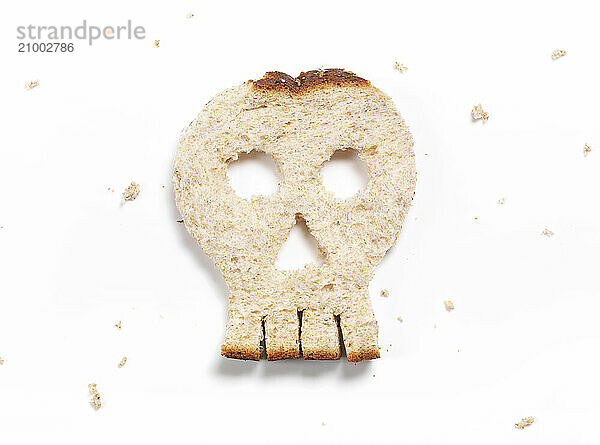 Skull made of bread isolated on white background