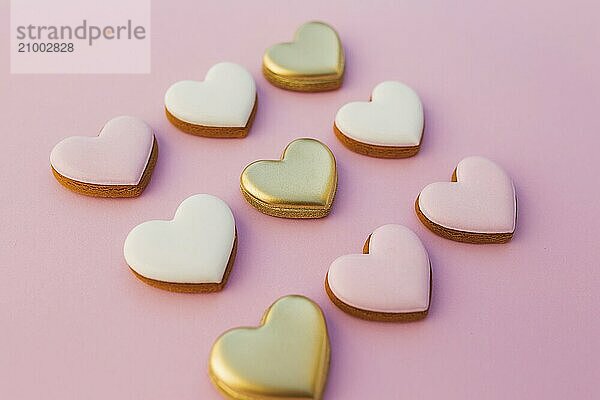 Pink background with sweet gingerbread heart cookies.