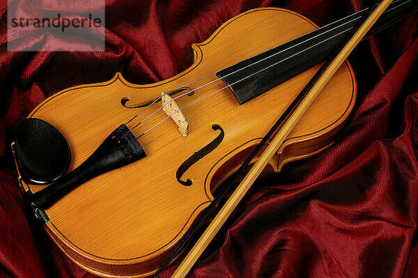 Violin on red background musical still life