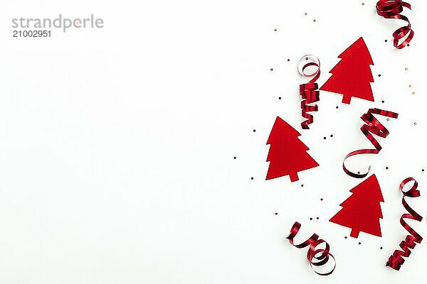 Christmas trees with red ribbons and glitter stars on white background.