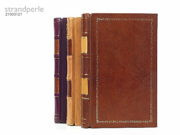 Three volumes of hardcover leather bound book isolated on white background. Vintage books