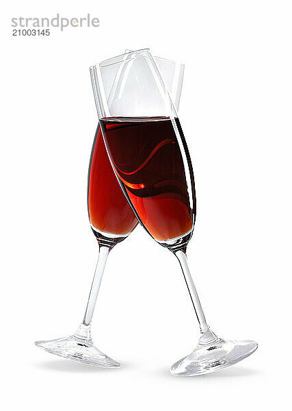 Two crossed wineglasses with red wine artistic still life isolated on white. Love and Valentines Day romantic concept