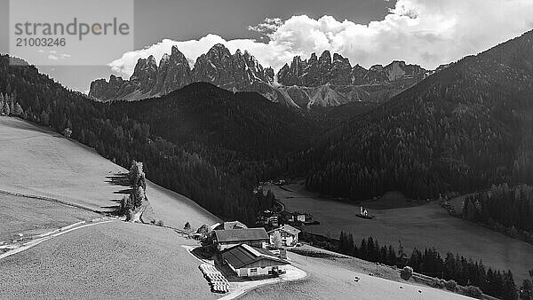 Farm and alpine meadows  in the background the peaks of the Geisler group  drone shot  black and white  Sankt Magdalena  Villnößtal  Dolomites  Autonomous Province of Bolzano  South Tyrol  Italy  Europe