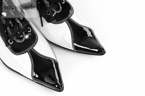 Toes of fancy lacquered black and white retro shoes