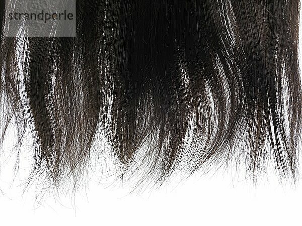 Closeup of dark brown hair ends isolated on white background