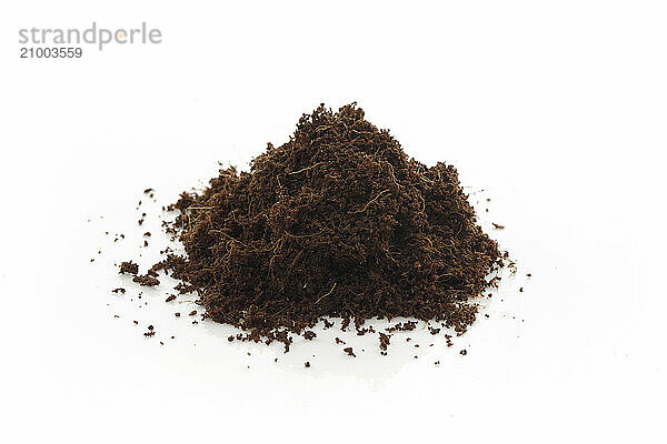 Coconut coir or Coco coir  growing media used in horticulture and gardening instead or as an organic amendment to soil. Closeup of an isolated cone pile on white studio background