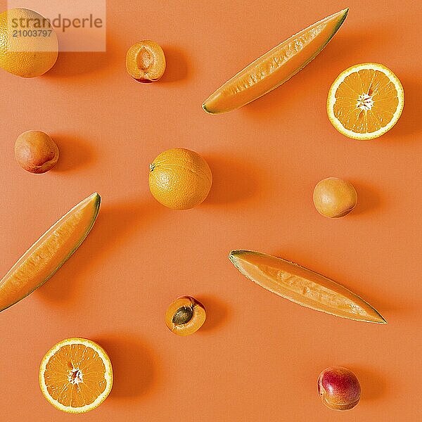 Fresh orange toned fruits over an orange background