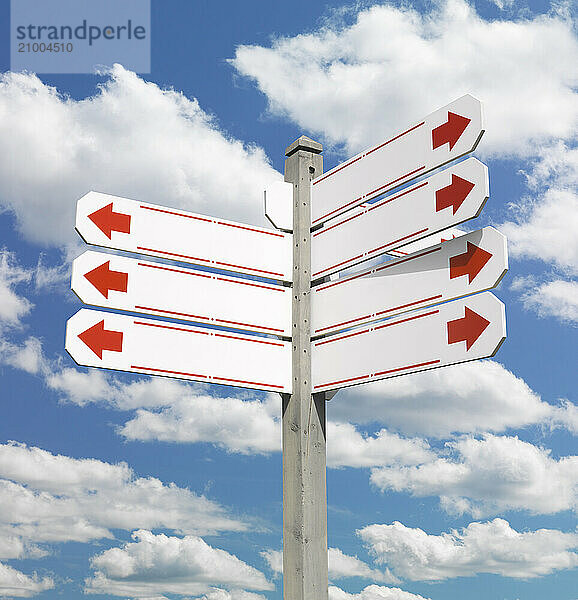 Direction signpost with blank signs over on blue sky background