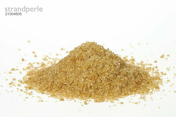 Pile of granulated natural brown sugar Isolated on white