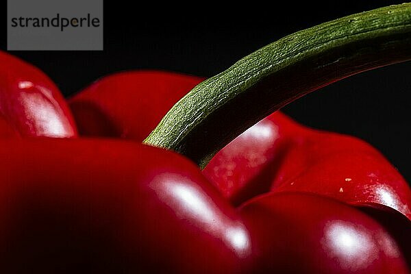 Detail of a red pepper  capsicum  on black background