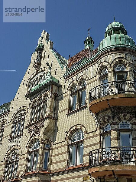 Old-fashioned building with decorated balconies and green roof under a clear sky  trelleborg  sweden  baltic sea  scandinavia