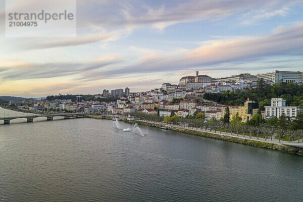 Coimbra drone aerial city view at sunset with Mondego river and beautiful historic buildings  in Portugal