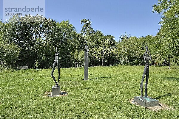 Sculptures From man to man by Hannes Helmke  modern art  three  slender thin naked figures  male figure  female figure  sitting  standing  black  bronze  sculpture park  Niederhöchstadt  Eschborn  Taunus  Hesse  Germany  Europe