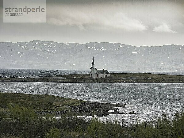 Nesseby town church  with congregation standing outside on Whit Sunday  May  Varanger Fjord  Norway  Europe