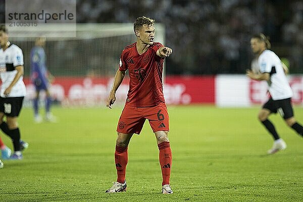 Football match  Joshua KIMMICH FC Bayern Munich shows with his right arm in which direction to go  football stadium Donaustadion  Ulm  Germany  Europe