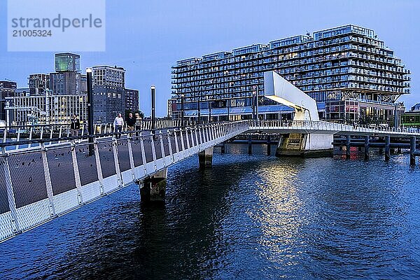 The former Fenix warehouse  left  from 1923  destroyed in the war  renovated in 2019  converted into a residential and commercial building  with hotel  flats  restaurants  offices  warehouses  on the Rijnhaven harbour basin  Rijnhavenbrug  bridge  Rotterdam  Netherlands