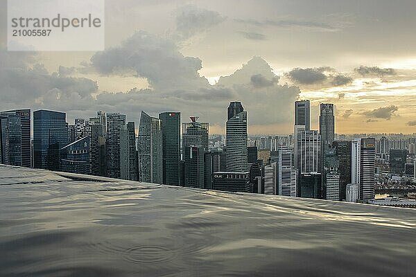 City skyline  view of the city and harbour from a skyscraper. Sunset in the rainy season  taken from the Marina Bay Sands Hotel  Singapore  Asia