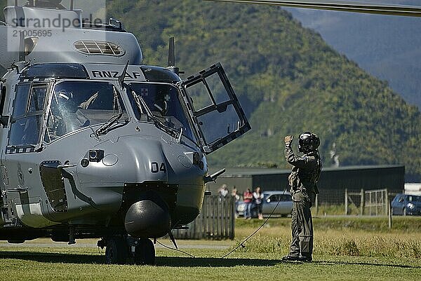 GREYMOUTH  NEW ZEALAND  NOVEMBER 18  2017: An unidentified crew member makes a pre-flight check on an Air Force NH90 helicopter at an open day run by the New Zealand armed forces. The NH90 was built by NATO Helicopter Industries (NHI) France