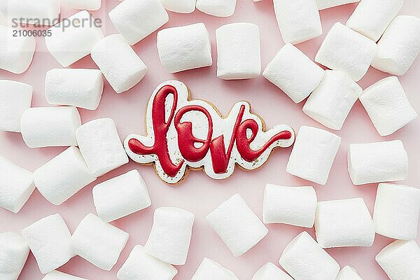 Gingerbread cookies love with white marshmallow. Valentine card. Pink background.